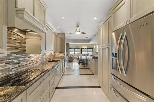 a bathroom with a granite countertop sink a mirror and a shower