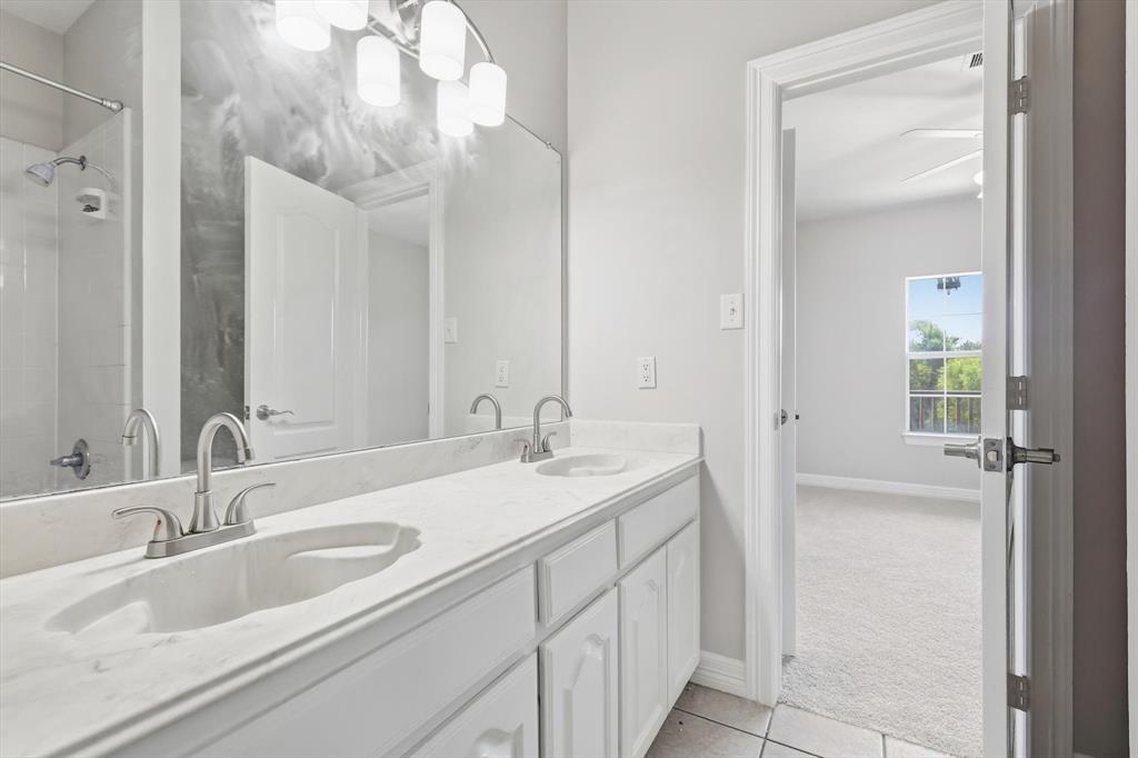 3521 Bay Ridge Drive Little Elm, TX 75068 - Photo 21 of 38 a bathroom with a sink and a mirror