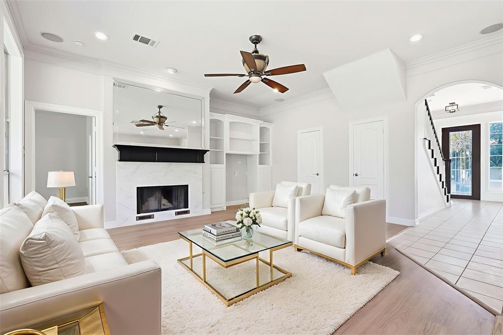 3521 Bay Ridge Drive Little Elm, TX 75068 - Photo 4 of 38 a living room with furniture a fireplace and a ceiling fan
