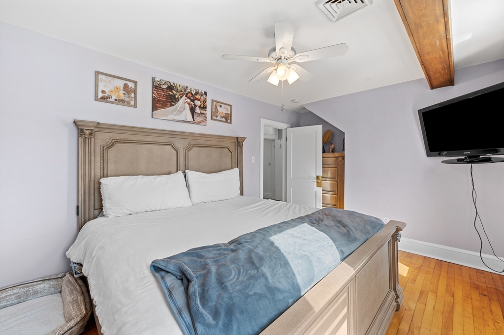 28 Barnard Road Worcester, MA 01605 - Photo 18 of 29 a bedroom with a large bed and a flat screen tv