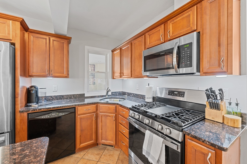 28 Barnard Road Worcester, MA 01605 - Photo 5 of 29 a kitchen with granite countertop stainless steel appliances a stove sink and microwave
