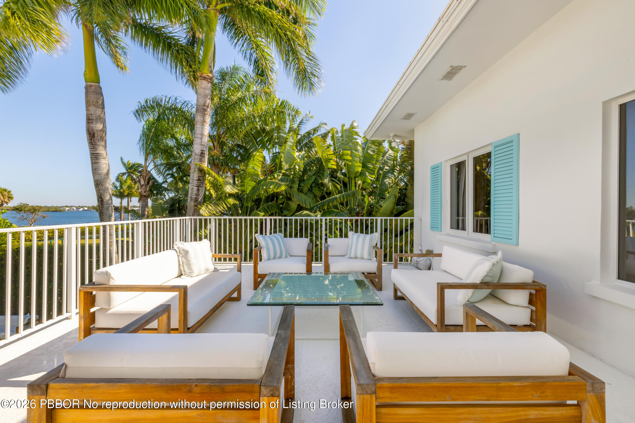 121 Seville Road West Palm Beach, FL 33405 - Photo 40 of 67 a view of a patio with couches table and chairs and potted plants