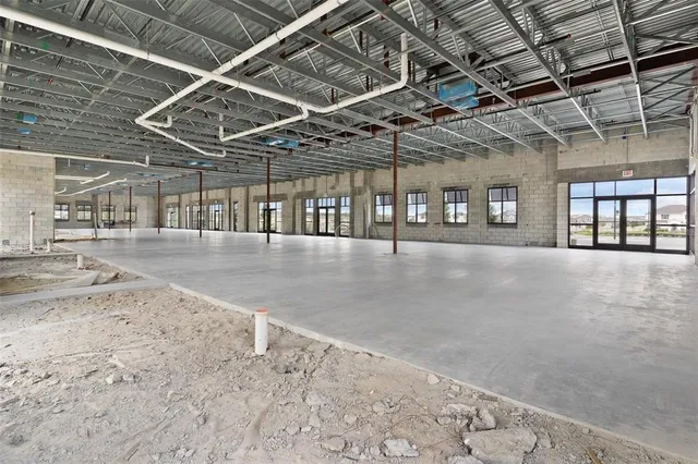 a view of a hall with wooden floor
