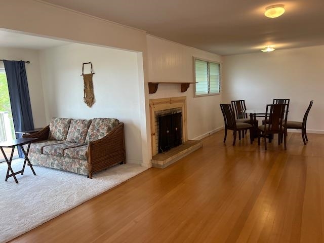 221 Upper Kimo Drive Kula, HI 96790 - Photo 8 of 21 a living room with furniture a fireplace and a dining table with wooden floor