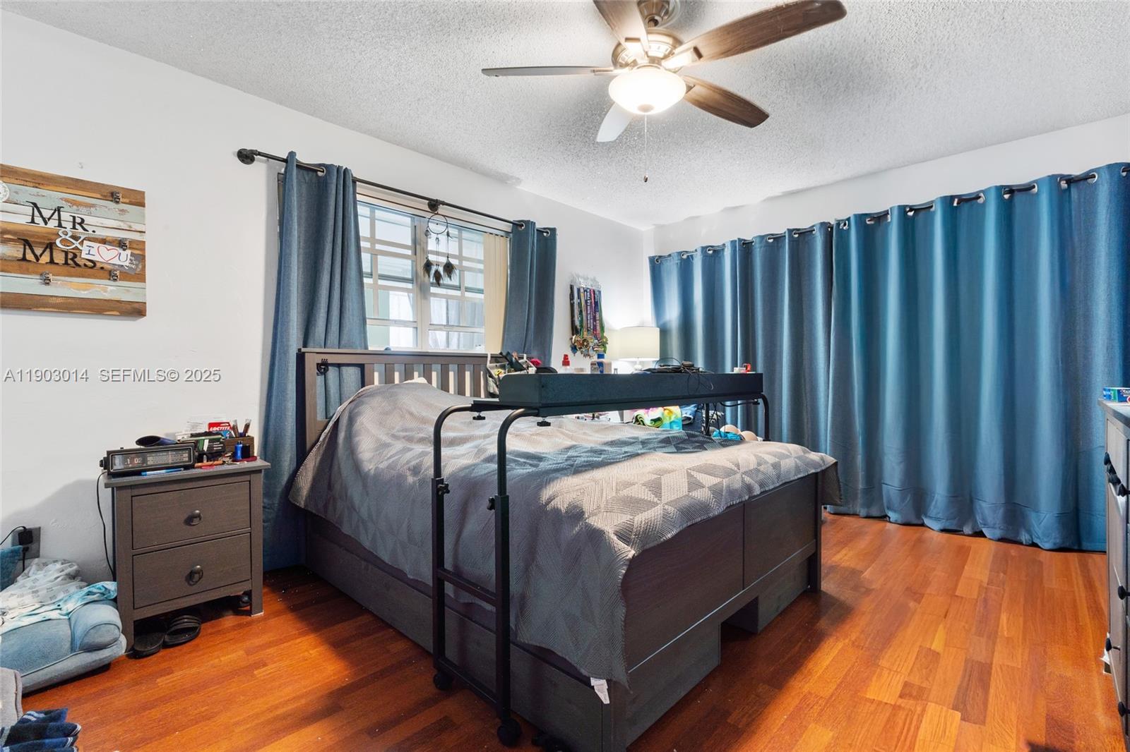 7144 West 2nd Lane Hialeah, FL 33014 - Photo 22 of 40 a bedroom with a bed and wooden floor