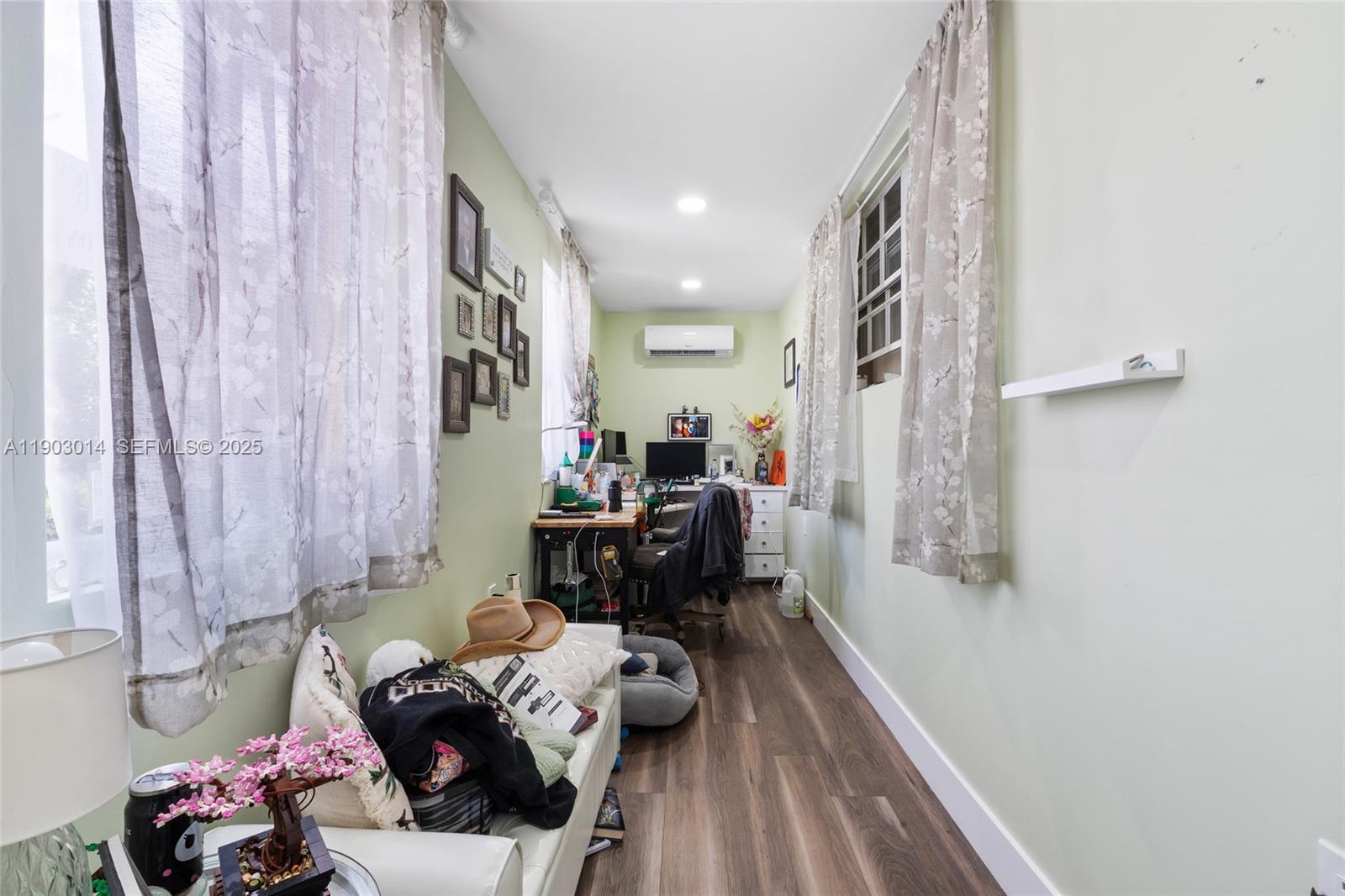 7144 West 2nd Lane Hialeah, FL 33014 - Photo 23 of 40 a living room with furniture and a chandelier