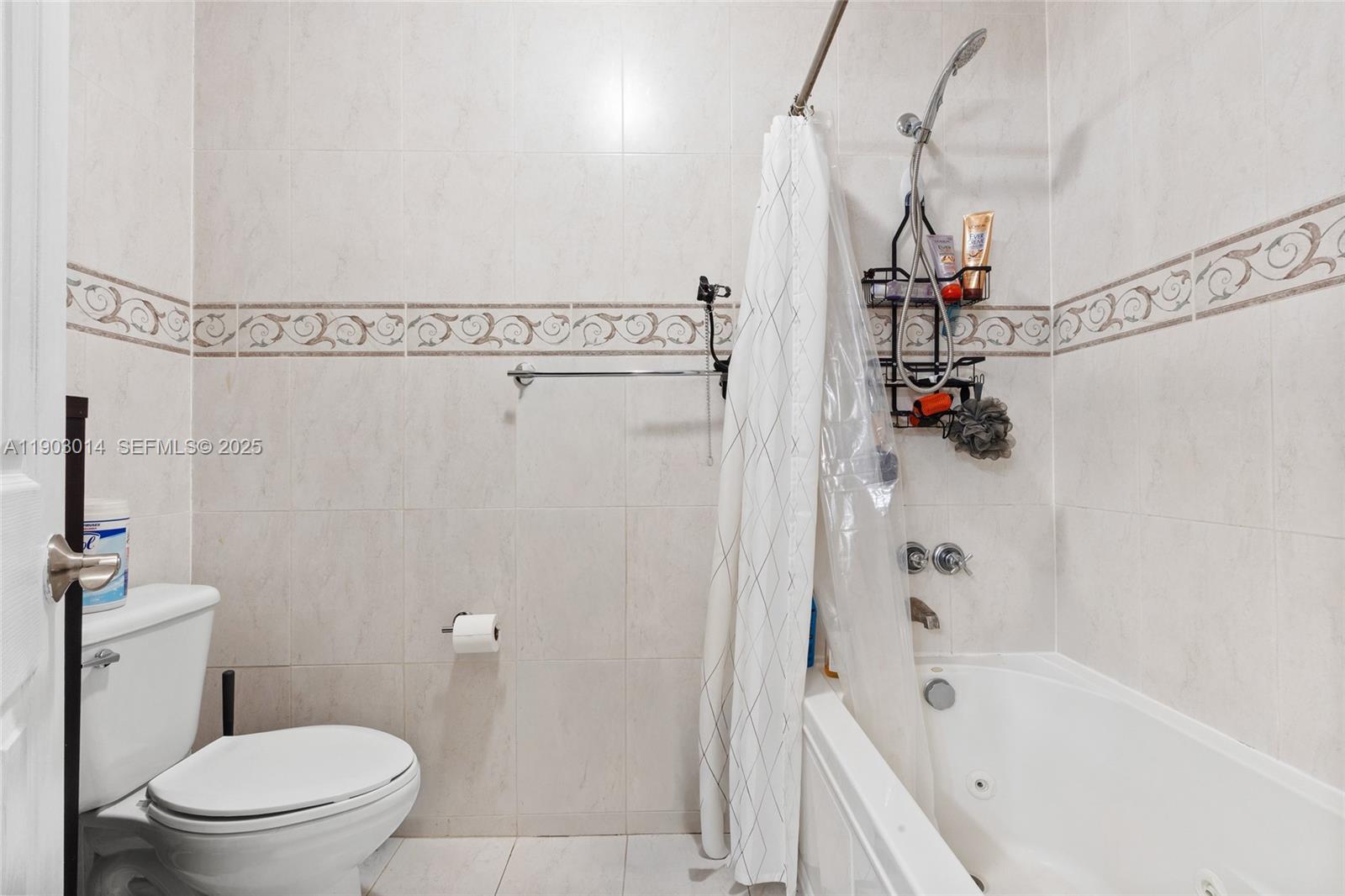 7144 West 2nd Lane Hialeah, FL 33014 - Photo 24 of 40 a bathroom with a bathtub and a toilet