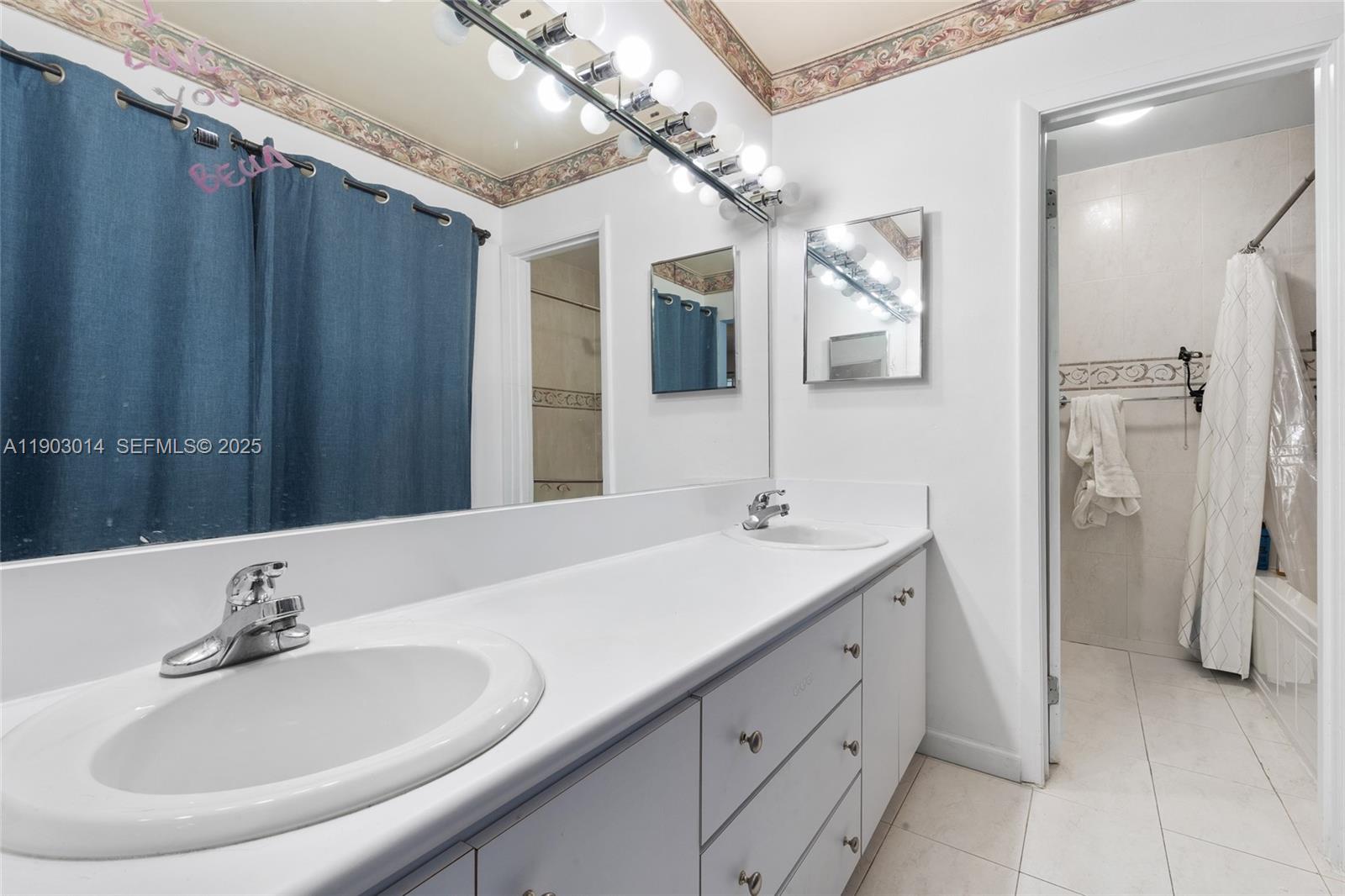 7144 West 2nd Lane Hialeah, FL 33014 - Photo 26 of 40 a bathroom with a double vanity sink and mirror