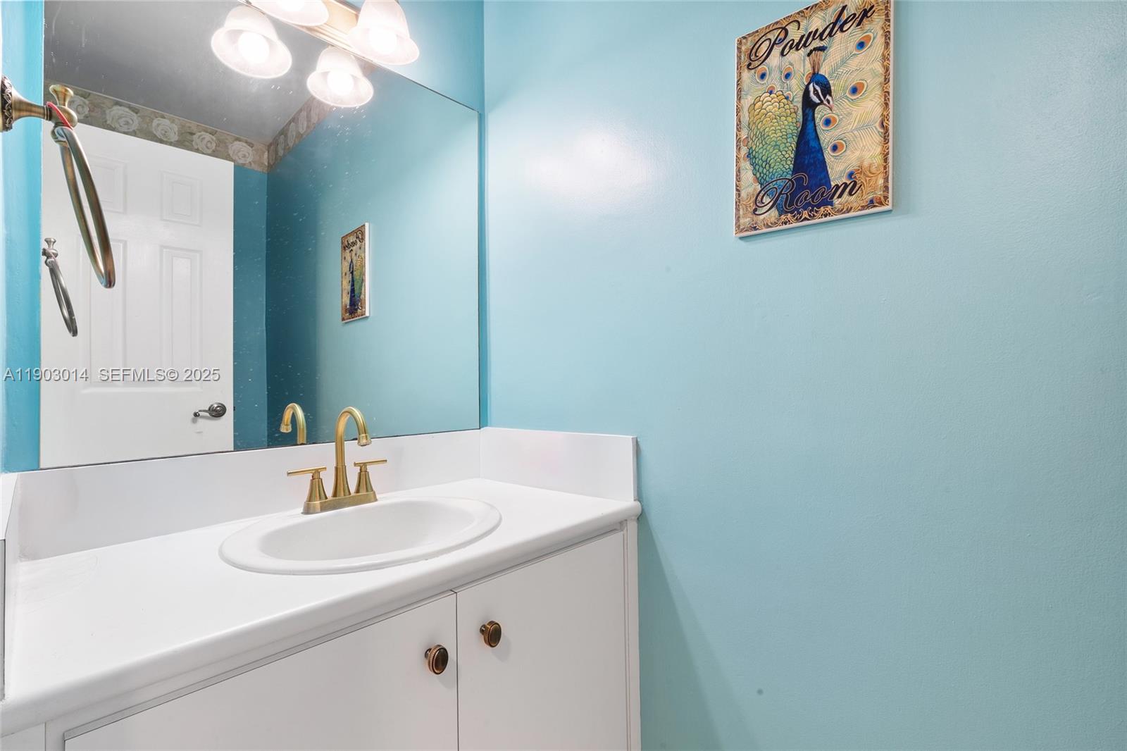 7144 West 2nd Lane Hialeah, FL 33014 - Photo 10 of 40 a bathroom with a sink and a mirror