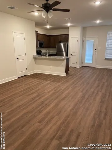 a view of a livingroom with a microwave and furniture