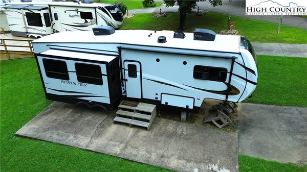 a view of a chairs and table in the backyard