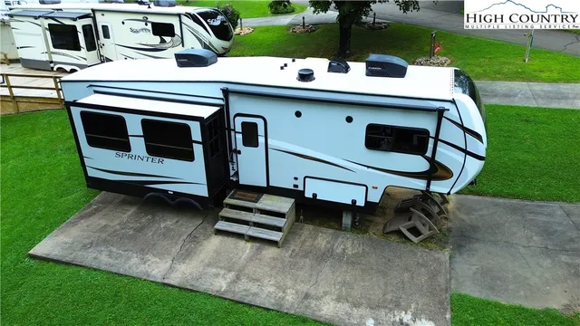 a view of a chairs and table in the backyard