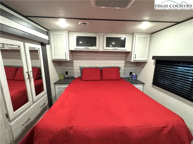 a bedroom with a bed and a television