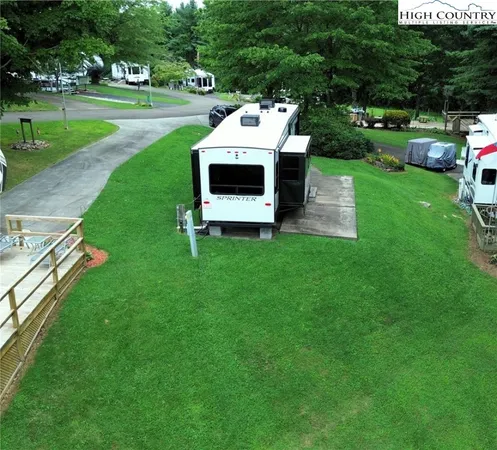 a view of a house with a big yard and a large park