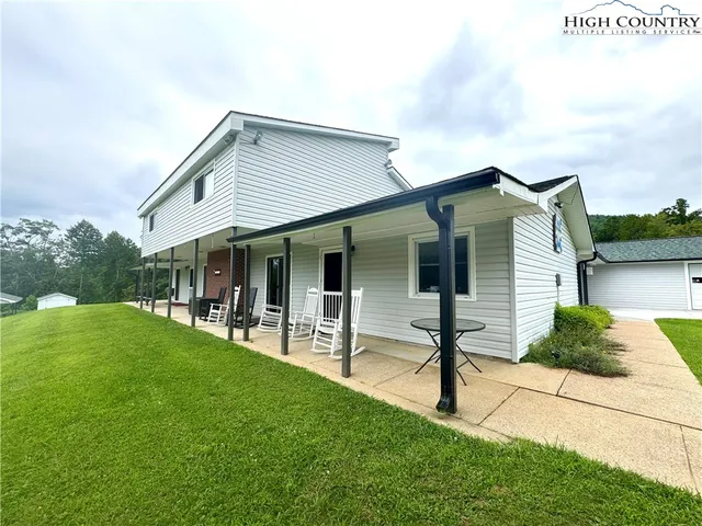 a view of an house with backyard porch and sitting area