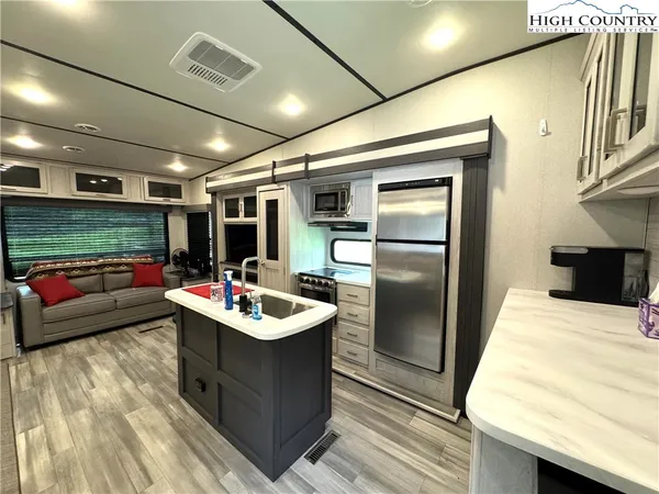 a kitchen with a sink stove and refrigerator