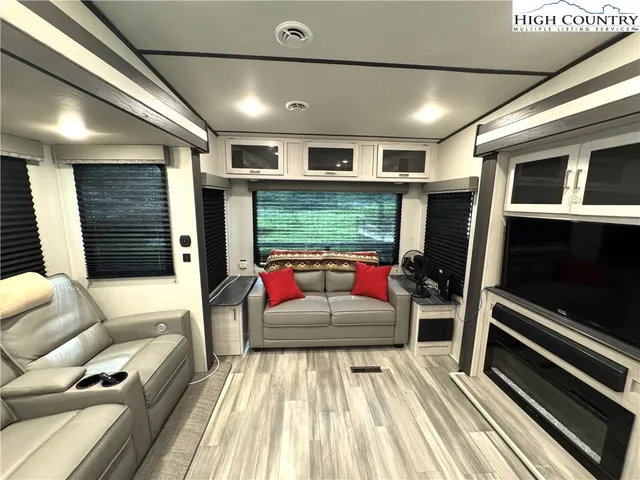 a living room with furniture stove and a fireplace