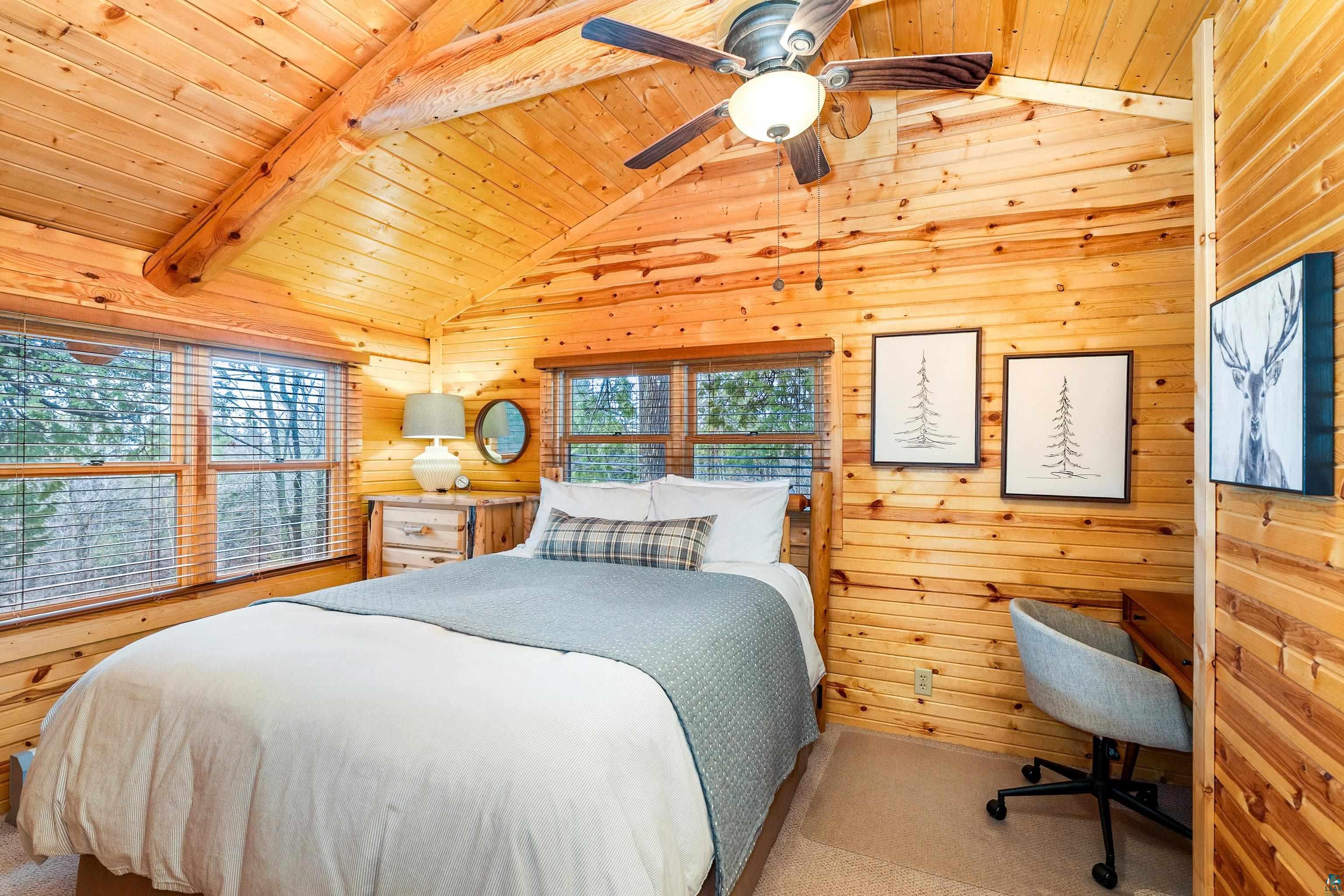 2659 Ridgeview Drive Two Harbors, MN 55616 - Photo 24 of 56 Wood-paneled room featuring a vaulted ceiling with exposed beams, multiple windows with blinds, and a ceiling fan with light fixture