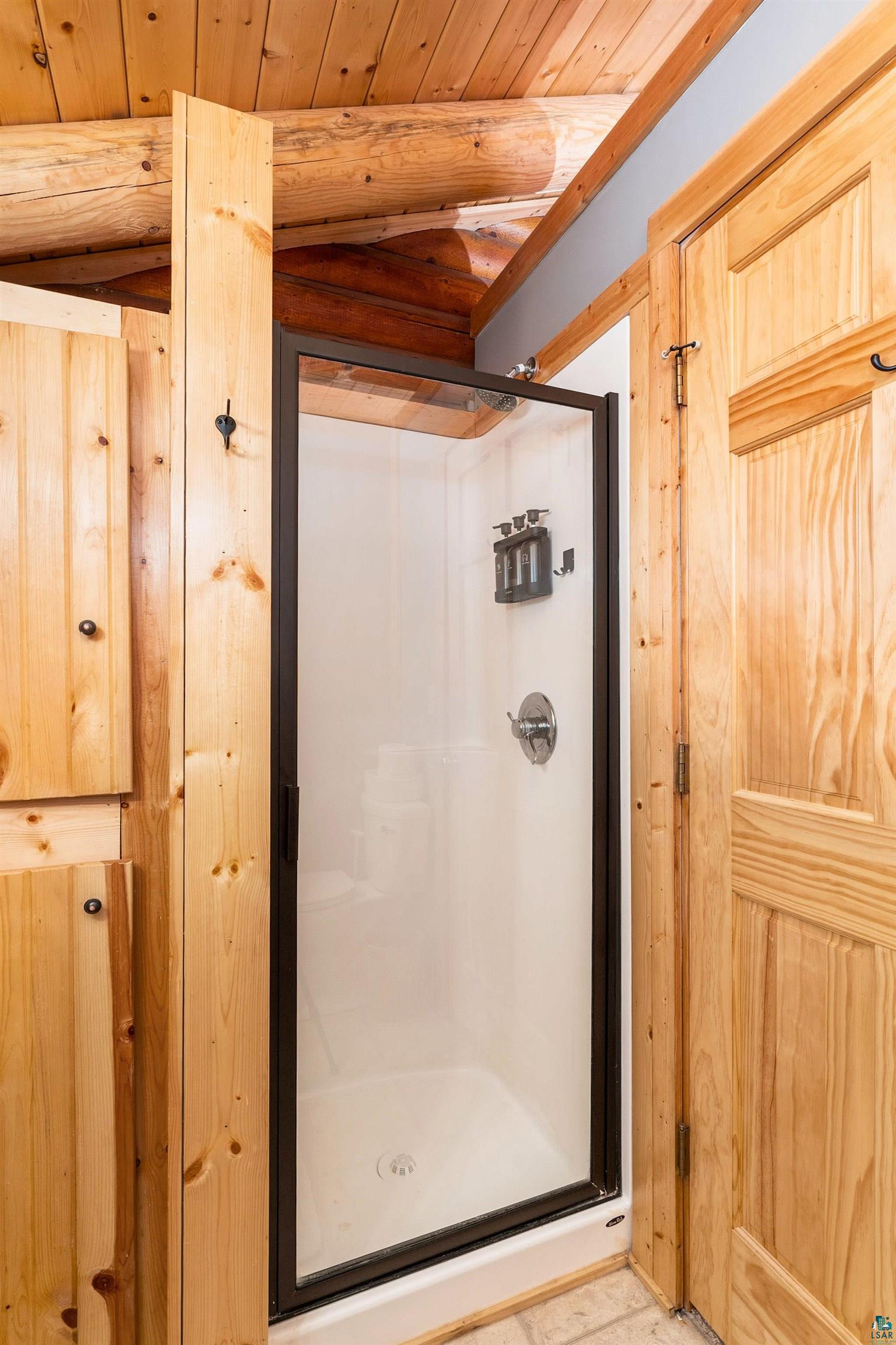 2659 Ridgeview Drive Two Harbors, MN 55616 - Photo 27 of 56 Shower stall with a dark-framed glass door, white surround, and a chrome shower fixture