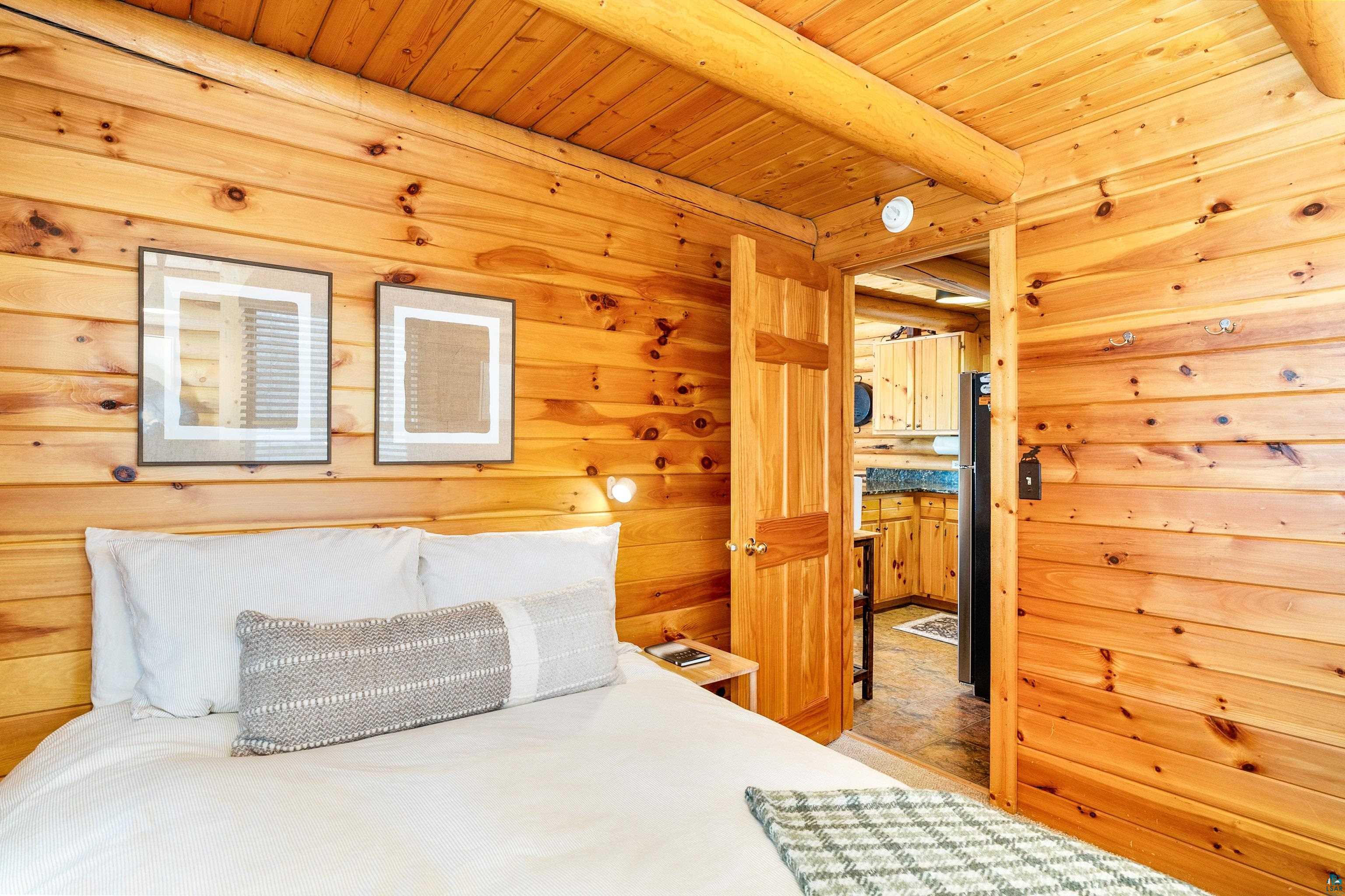 2659 Ridgeview Drive Two Harbors, MN 55616 - Photo 29 of 56 Rustic interior with natural wood-paneled walls and ceiling, featuring a solid wood door frame