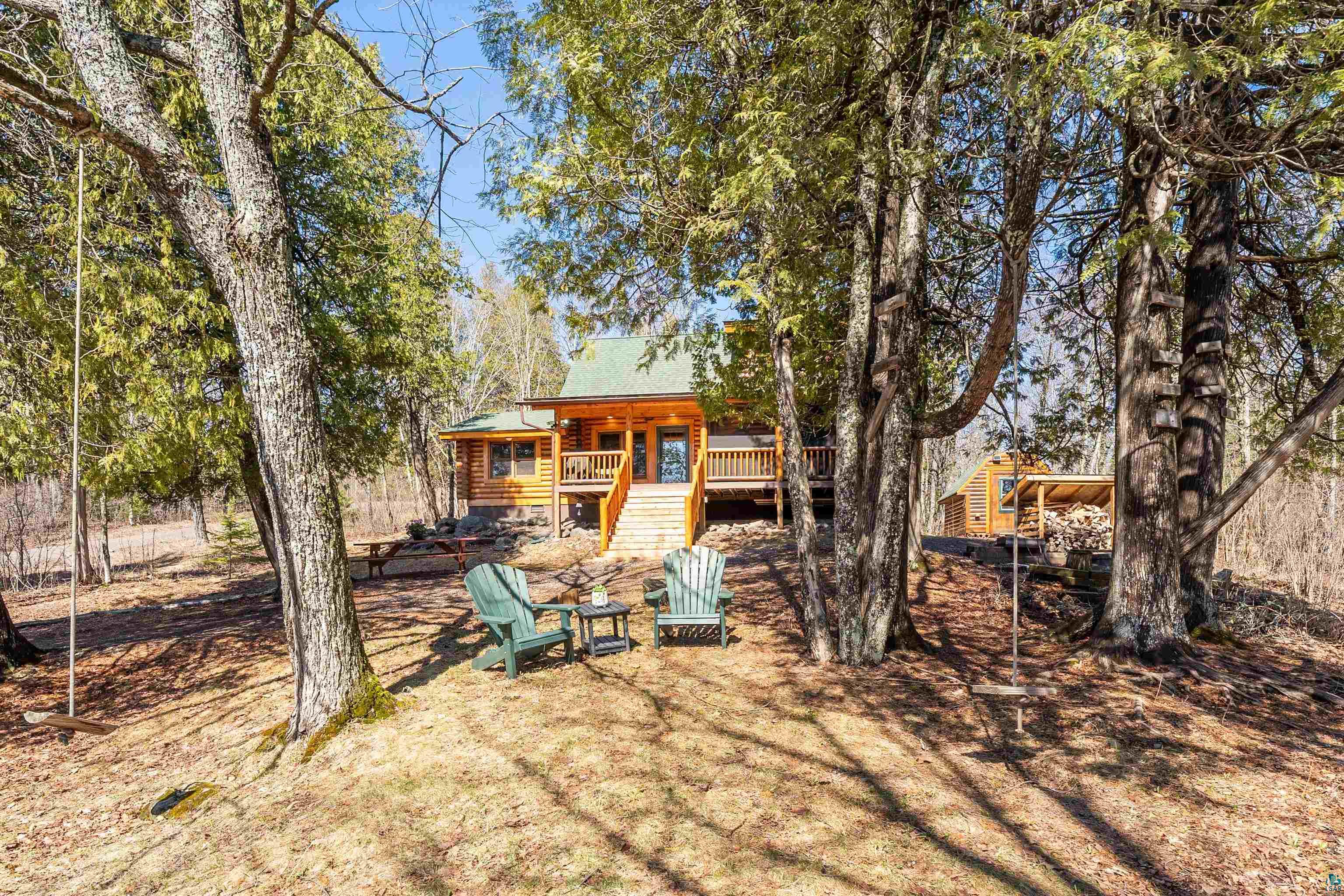 2659 Ridgeview Drive Two Harbors, MN 55616 - Photo 43 of 56 Wood-clad cabin exterior featuring a covered porch, outdoor stairs, and a green metal roof