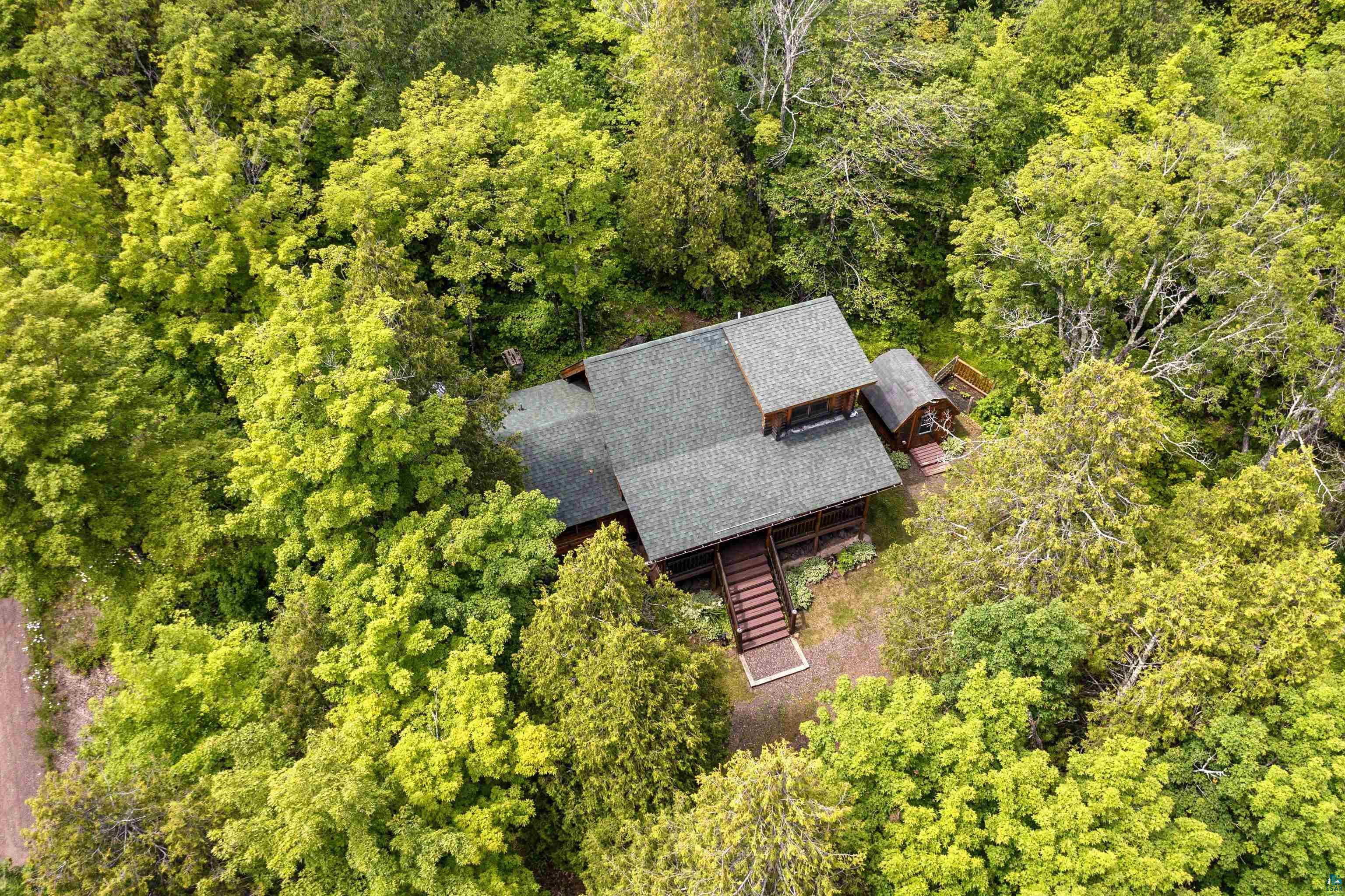 2659 Ridgeview Drive Two Harbors, MN 55616 - Photo 55 of 56 Wooded property featuring a multi-level residence with a gray shingle roof, dark siding, and multiple balconies