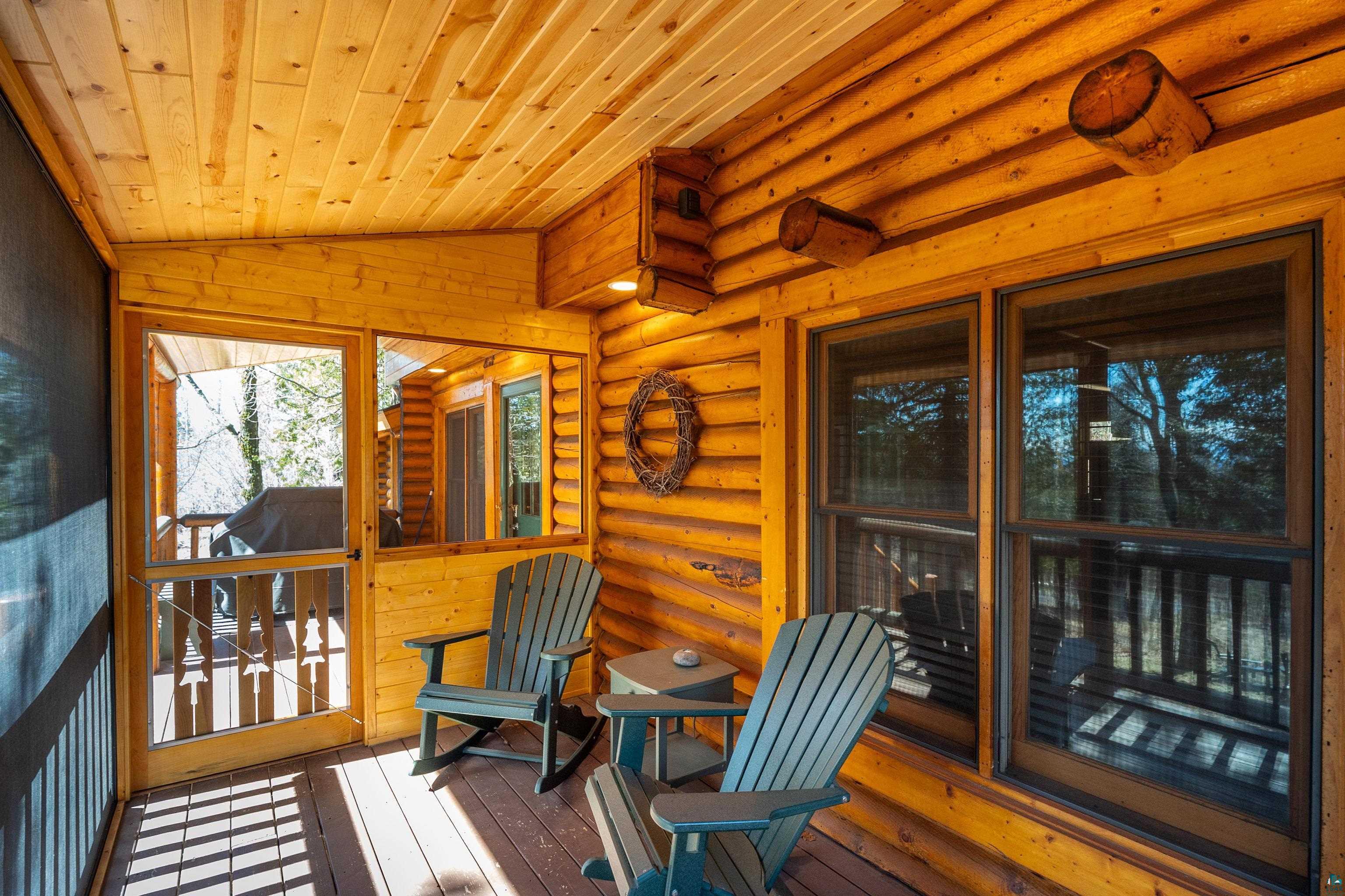 2659 Ridgeview Drive Two Harbors, MN 55616 - Photo 10 of 56 Screened porch featuring wood plank ceilings, log walls, wood-finish flooring, and exterior windows