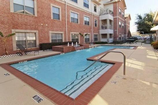 8707 Valley Ranch Parkway West, Unit 335 Irving, TX 75063 - Photo 11 of 11 a view of a swimming pool with outdoor seating