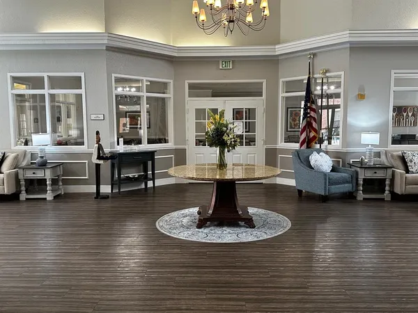 a living room with furniture and a chandelier