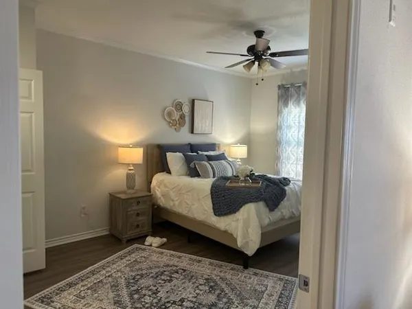 a bedroom with a bed and a chandelier