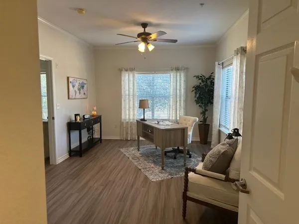 a view of a dining room with furniture and a window