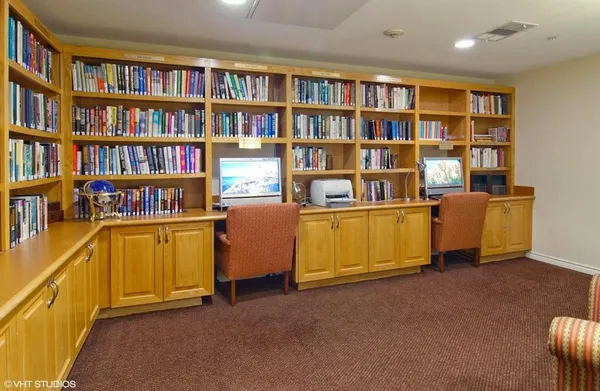 a view of a workspace with furniture and cabinet