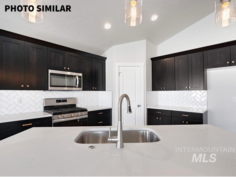 925 Twilight Weiser, ID 83672 - Photo 15 of 31 Kitchen featuring a large central island with an undermount sink and a gooseneck faucet