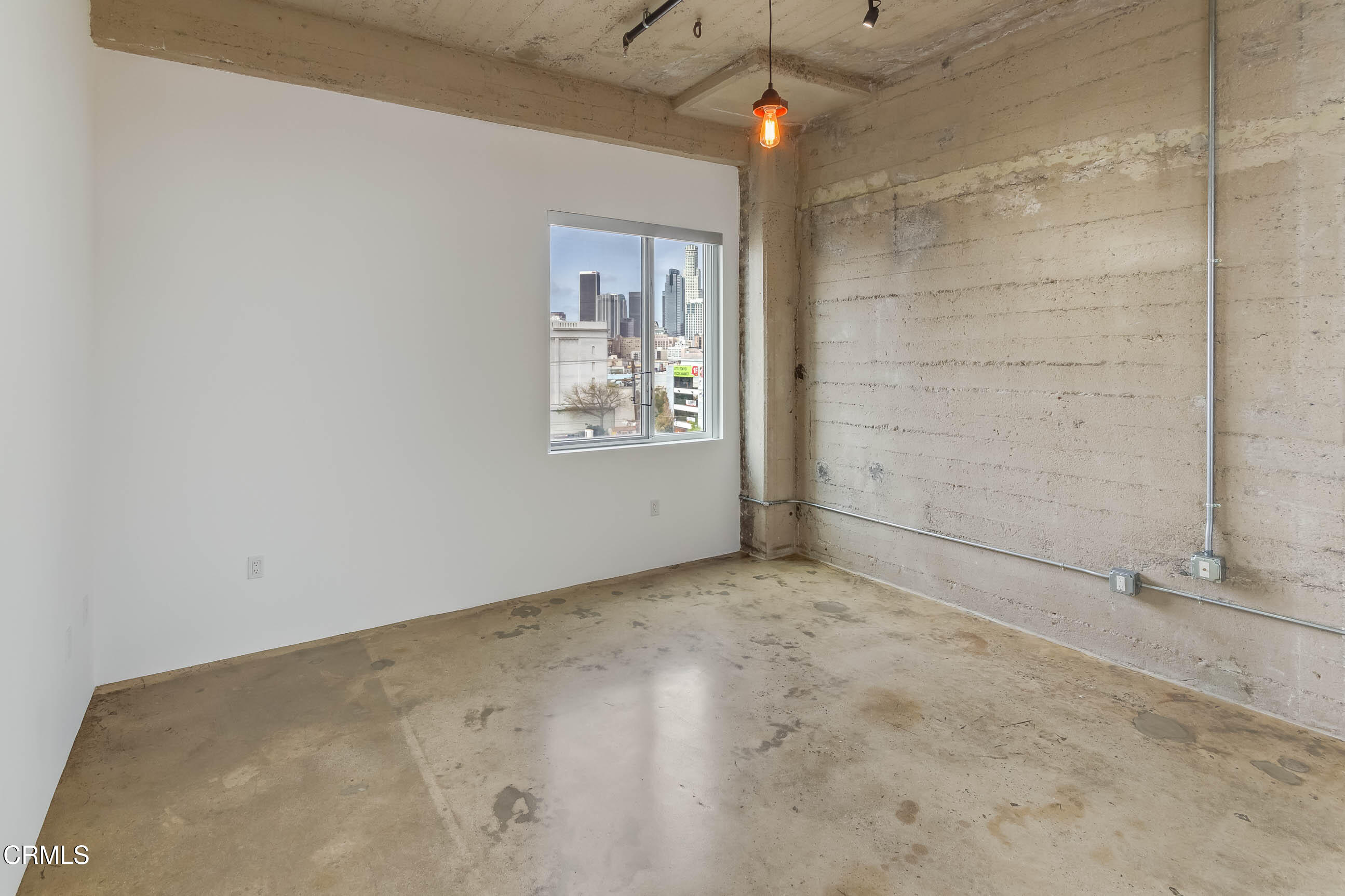 825 East 4th Street, Unit 501 Los Angeles, CA 90013 - Photo 13 of 19 an empty room with windows and fan