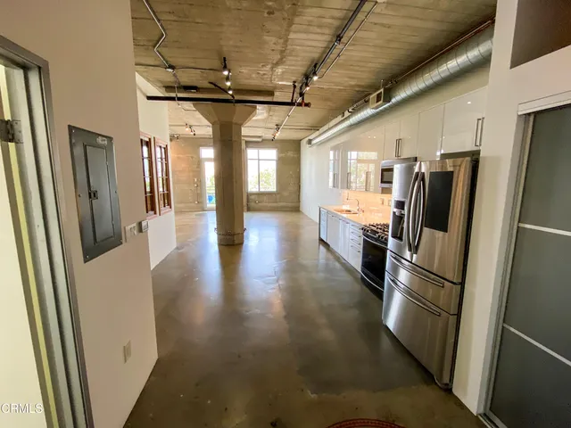 a kitchen with stainless steel appliances granite countertop a refrigerator and a refrigerator