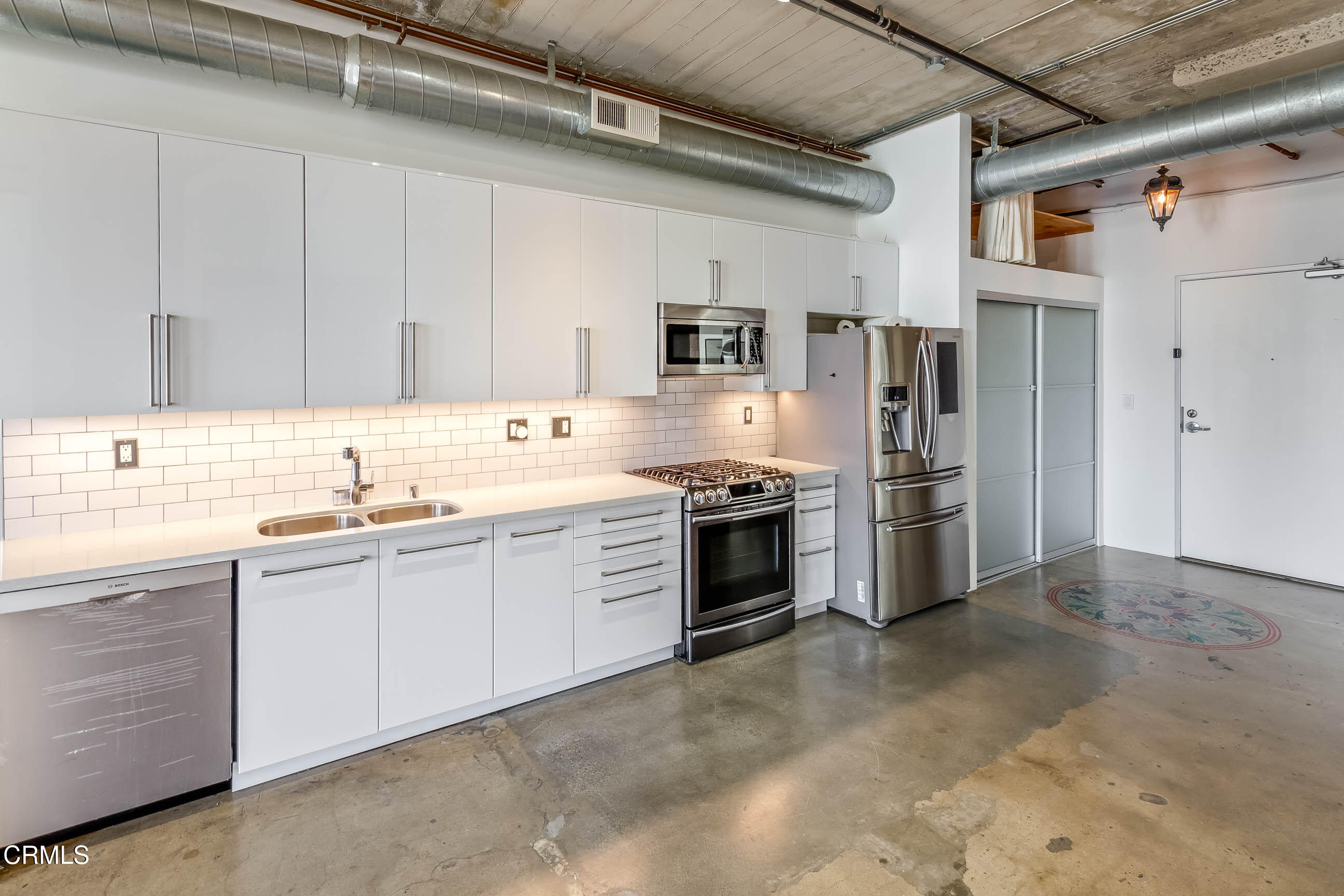 825 East 4th Street, Unit 501 Los Angeles, CA 90013 - Photo 8 of 19 a kitchen with stainless steel appliances granite countertop a refrigerator and a stove