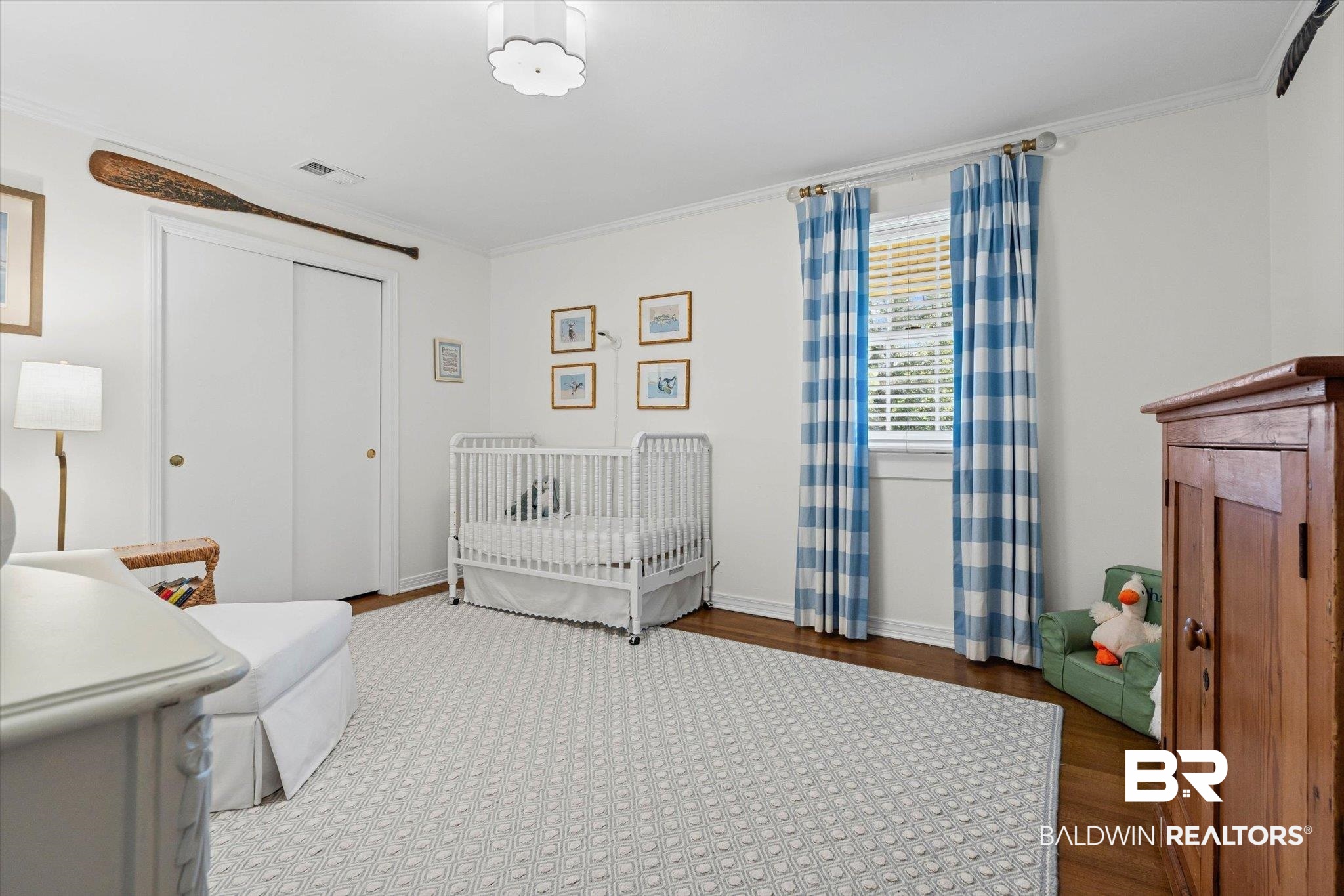 313 Brawood Drive Mobile, AL 36608 - Photo 21 of 32 Bedroom featuring wood finished floors, crown molding, a closet, and a crib