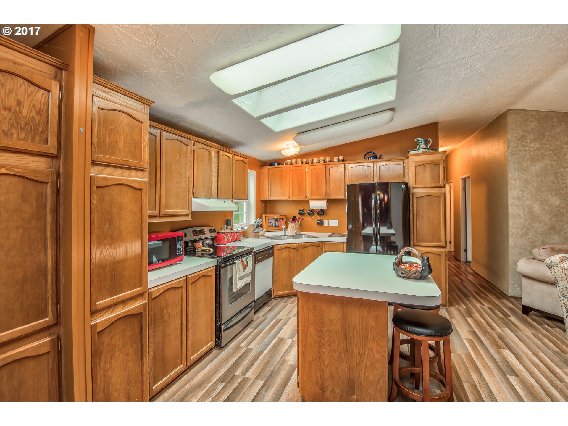 29964 South Hult Road Colton, OR 97017 - Photo 3 of 17 a kitchen with stainless steel appliances granite countertop sink stove refrigerator and cabinets