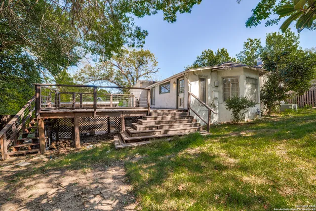 a view of a house with backyard and sitting area