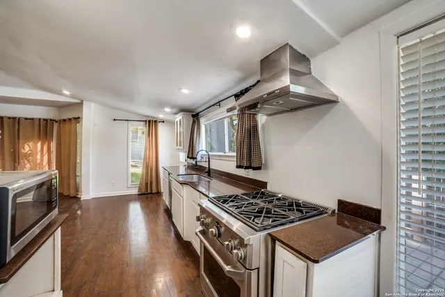a kitchen with stainless steel appliances granite countertop a stove and a refrigerator