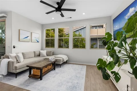 a living room with furniture and a potted plant