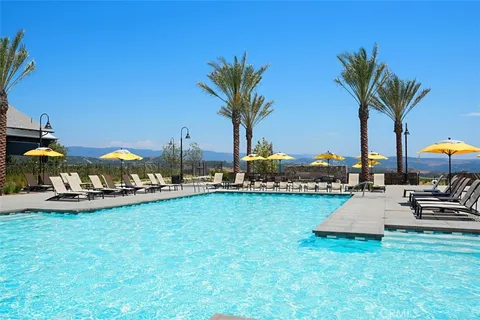 a view of a swimming pool and lounge chairs