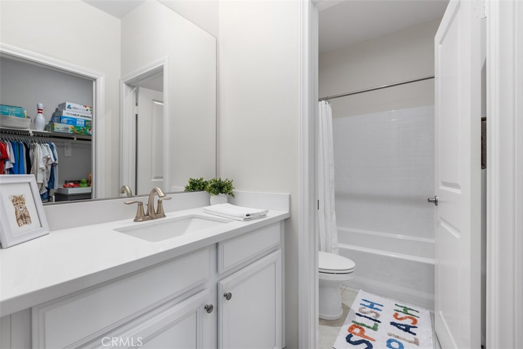 128 Natal Road Rancho Mission Viejo, CA 92694 - Photo 7 of 30 a bathroom with a sink a toilet and shower