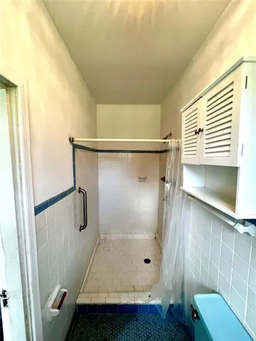 a bathroom with a glass door shower and a sink