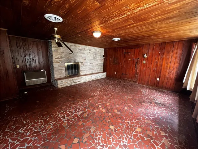 a view of an empty room with a fireplace