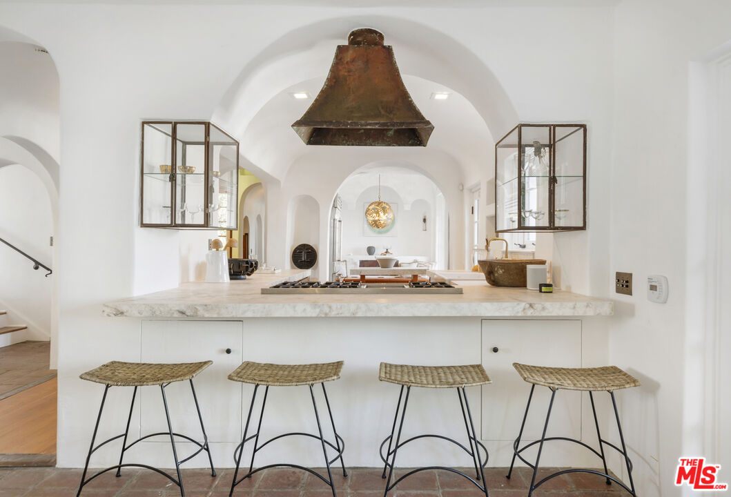 4565 Dundee Drive Los Angeles, CA 90027 - Photo 11 of 42 a large white kitchen with a sink and cabinets