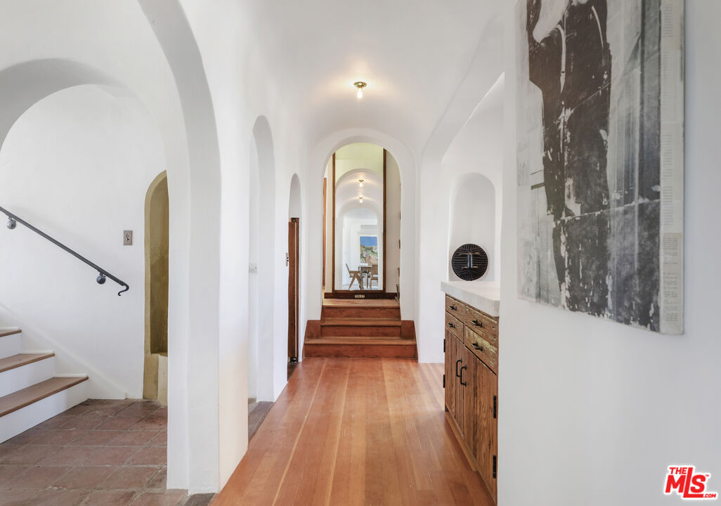 4565 Dundee Drive Los Angeles, CA 90027 - Photo 12 of 42 a view of a hallway view with wooden floor and staircase