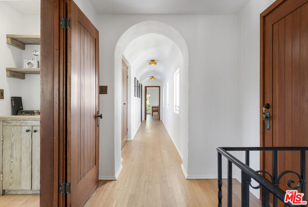 4565 Dundee Drive Los Angeles, CA 90027 - Photo 15 of 42 a view of a hallway with wooden floor and staircase