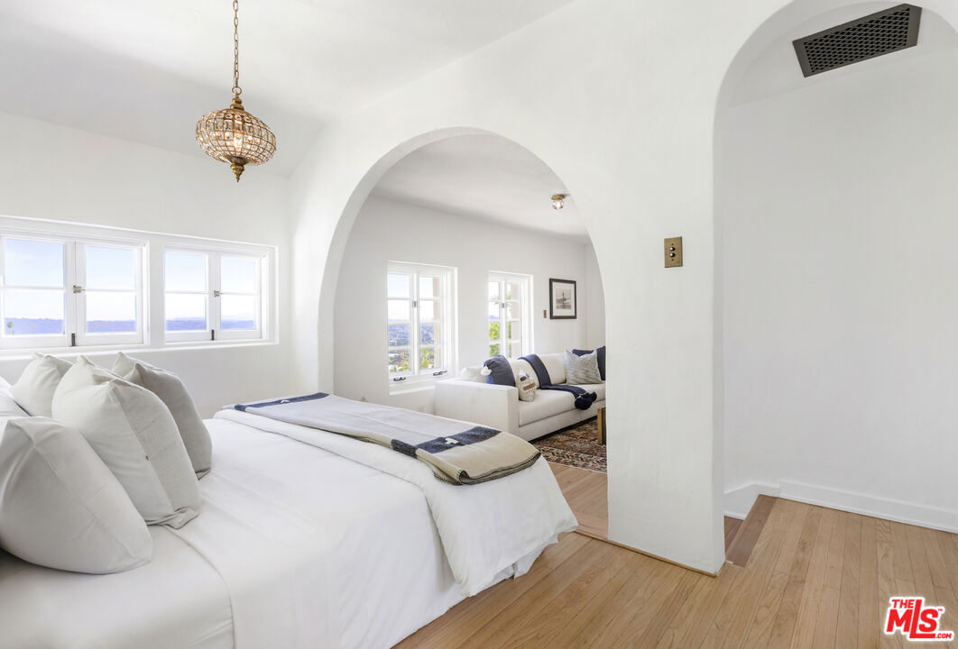 4565 Dundee Drive Los Angeles, CA 90027 - Photo 17 of 42 a bedroom with a bed and a window