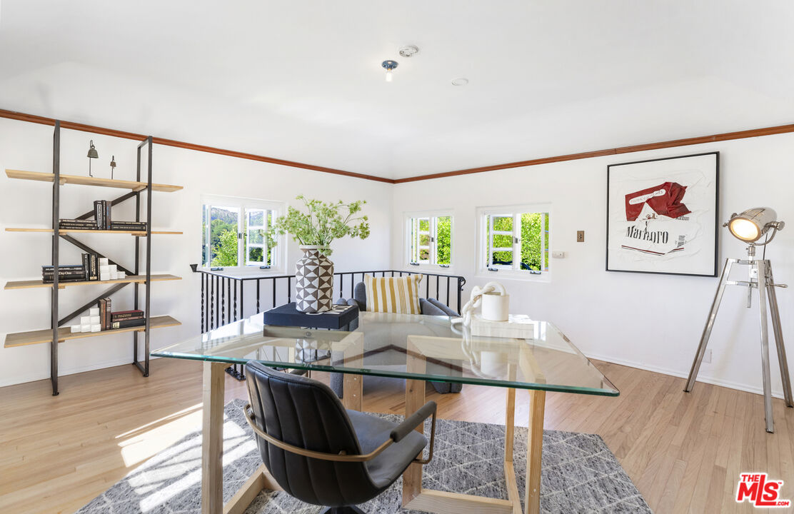 4565 Dundee Drive Los Angeles, CA 90027 - Photo 23 of 42 a workspace with furniture wooden floor and window